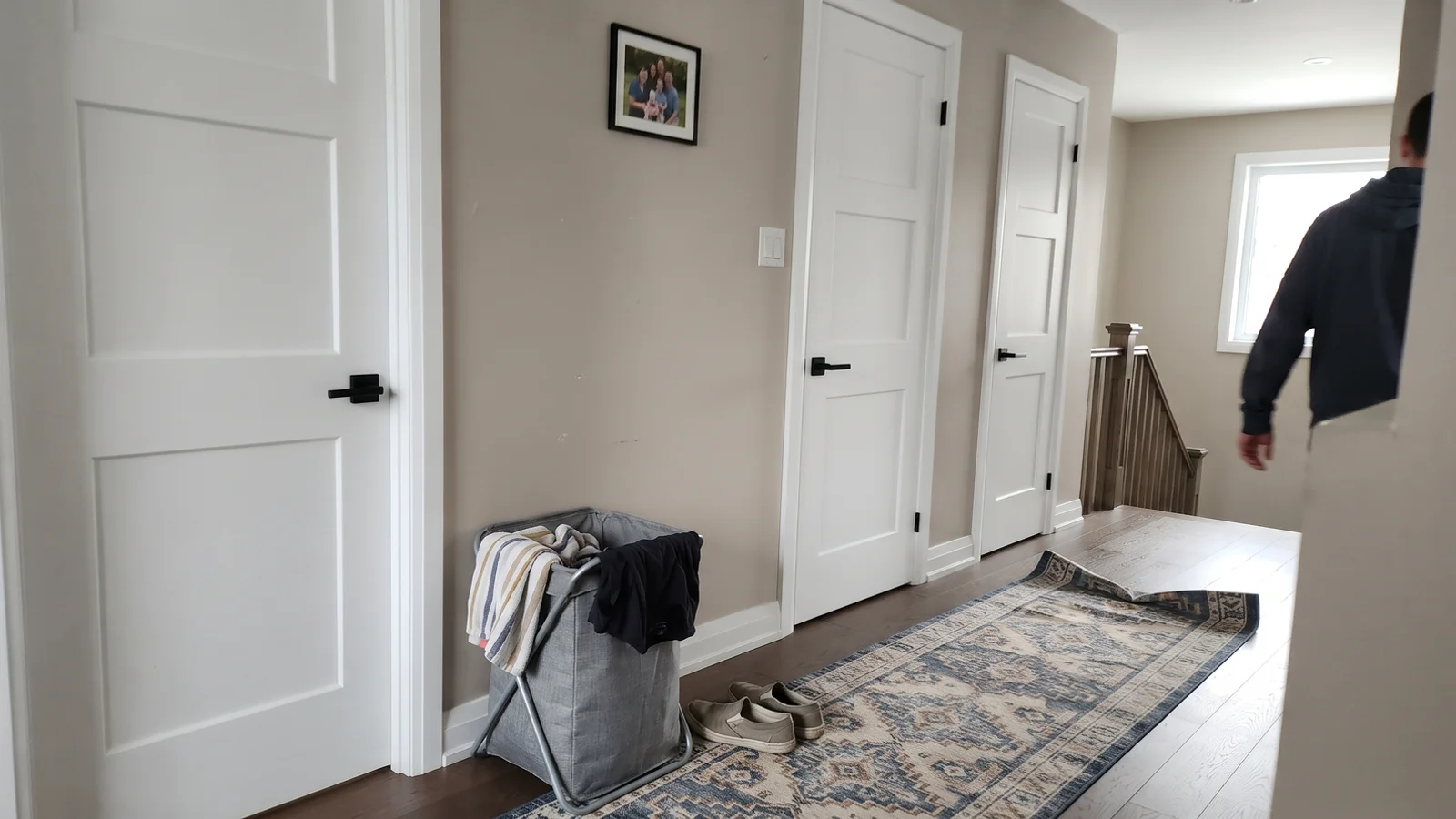 Newly installed white panel interior doors along a bright upstairs hallway
