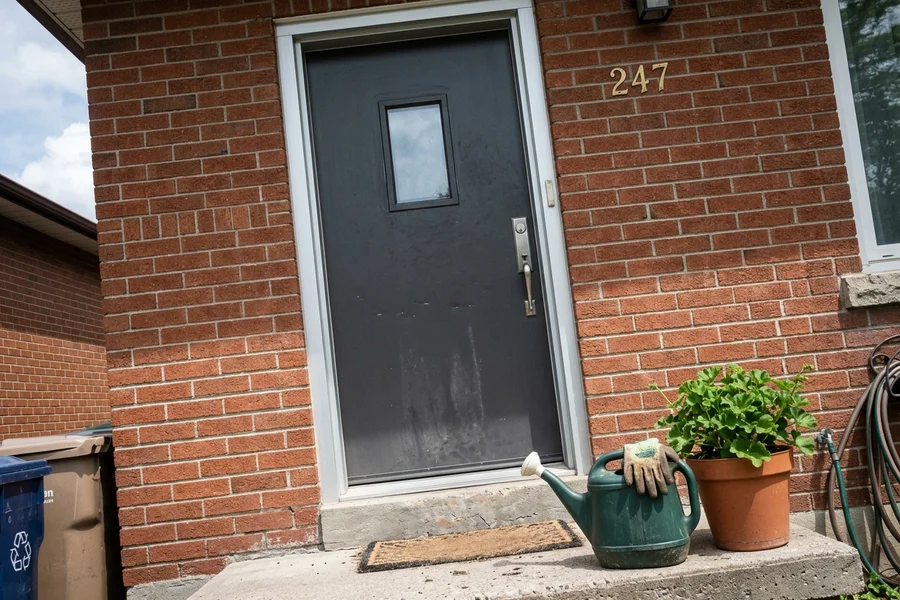 Charcoal steel entry door with aluminium jamb wrapping on a Scarborough home
